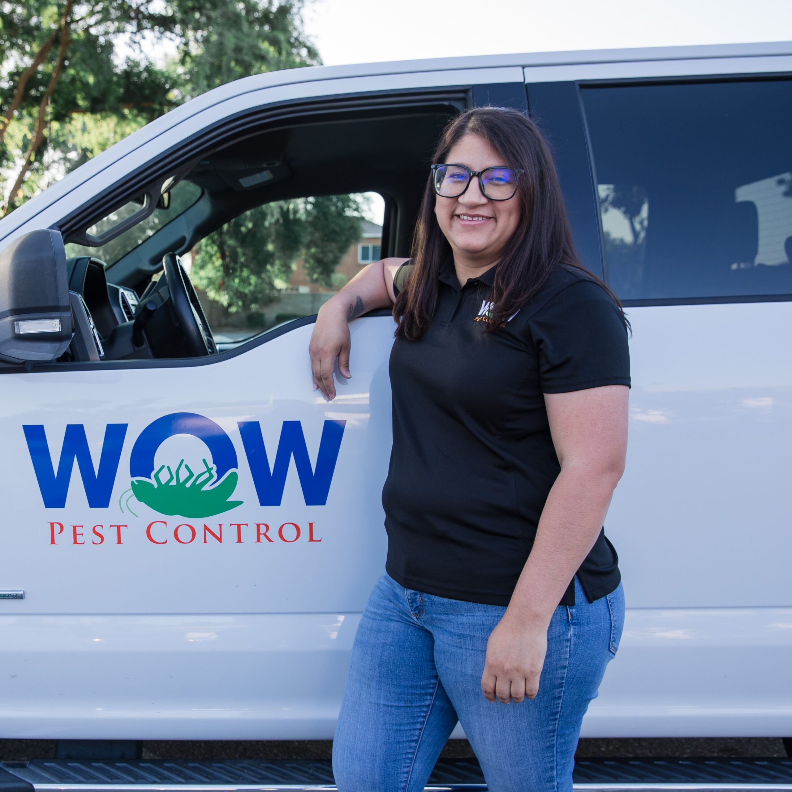 Picture of Wow Pest Control Customer Service Expert, Maritza Arteaga, next to a company truck.